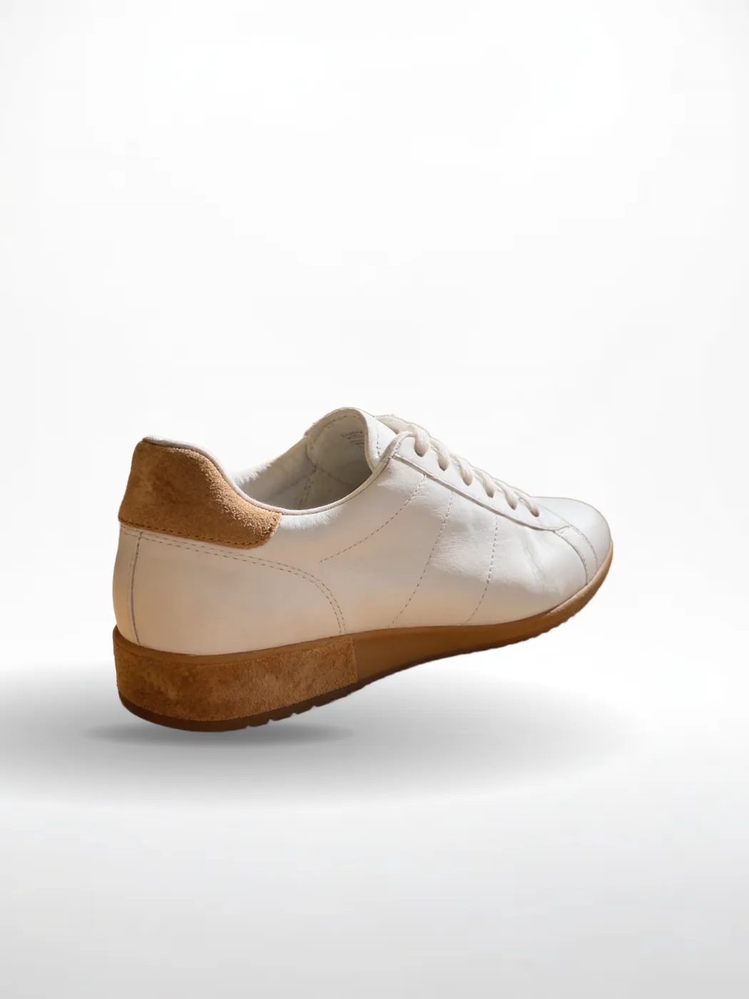 The same sneaker, unchanged, on a white studio background with a soft floor shadow